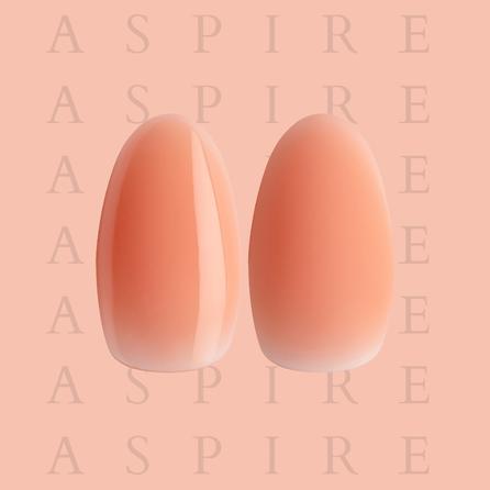 Two peach-colored nails with a gradient effect on a pink background with 'ASPIRE' 