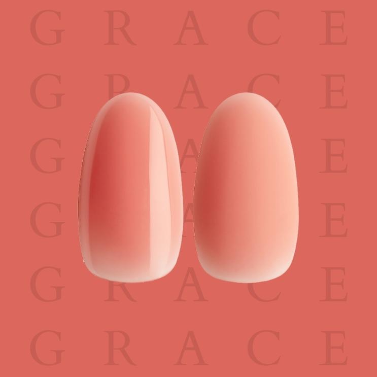 Two peach-colored nails on a coral background with 'GRACE' text.