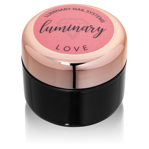 Luminary nail system container with pink lid on a white background